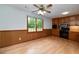 Eat-in kitchen featuring wood cabinets, updated appliances, and large window for natural light at 1810 King Mill Rd, Mcdonough, GA 30252