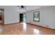 Bright living room features light hardwood floors, neutral walls and an exterior door to the yard at 1810 King Mill Rd, Mcdonough, GA 30252