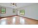 Bright living room featuring wood-look floors and large windows offering an abundance of natural light at 1810 King Mill Rd, Mcdonough, GA 30252