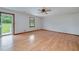 Bright living room features light hardwood floors and a large window overlooking the yard at 1810 King Mill Rd, Mcdonough, GA 30252