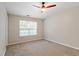 Bedroom features a ceiling fan, plush carpet, and a window at 1823 Devon Dr # 1823, Atlanta, GA 30311