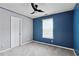 Bright bedroom with blue accent wall, carpet, and natural light at 1823 Devon Dr # 1823, Atlanta, GA 30311