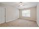 Bedroom features a ceiling fan, plush carpet, and natural light at 1823 Devon Dr # 1823, Atlanta, GA 30311
