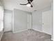 Neutral bedroom with gray walls, gray carpet, ceiling fan, and three doors at 1823 Devon Dr # 1823, Atlanta, GA 30311