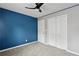 Bedroom with a bold blue accent wall, ceiling fan, and closet at 1823 Devon Dr # 1823, Atlanta, GA 30311