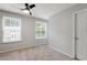Cozy bedroom featuring natural light from two windows and modern ceiling fan at 1823 Devon Dr # 1823, Atlanta, GA 30311