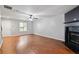 Bright living room features a ceiling fan, fireplace, and wood-look floors at 1823 Devon Dr # 1823, Atlanta, GA 30311