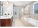 Bright bathroom features a double sink vanity, large tub, and glass shower at 1946 Jeffery Nw Rd, Atlanta, GA 30318