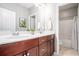 Bathroom with double sinks, dark wood cabinets, and a view of the shower and tub area at 1946 Jeffery Nw Rd, Atlanta, GA 30318