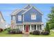 Inviting two-story home boasts blue siding and stone accents, enhanced by a beautifully landscaped front yard at 1946 Jeffery Nw Rd, Atlanta, GA 30318