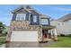Two-story home with blue siding, stone accents, white-trimmed windows, and well-maintained lawn at 1946 Jeffery Nw Rd, Atlanta, GA 30318