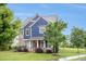 Two-story home with blue siding and stone accents, surrounded by mature trees and a green lawn at 1946 Jeffery Nw Rd, Atlanta, GA 30318