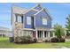 Two-story home featuring blue siding, stone accents, and well-maintained landscaping in a suburban neighborhood at 1946 Jeffery Nw Rd, Atlanta, GA 30318