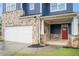Garage exterior with stone and blue lap siding, white trim, and red front door at 1946 Jeffery Nw Rd, Atlanta, GA 30318
