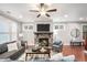 Well-lit living room features a stone fireplace, hardwood floors, and neutral tones for a relaxing ambiance at 1946 Jeffery Nw Rd, Atlanta, GA 30318