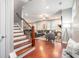 Inviting living room features hardwood floors, a staircase, a comfortable seating area, and natural light at 1946 Jeffery Nw Rd, Atlanta, GA 30318
