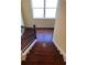 Wooden staircase descending from a naturally lit landing at 1946 Jeffery Nw Rd, Atlanta, GA 30318