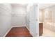Spacious walk-in closet with wire shelving and hardwood floors, located near a bathroom at 1946 Jeffery Nw Rd, Atlanta, GA 30318