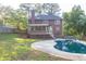 Picture of backyard featuring beautiful pool, landscaped yard, deck, screened-in porch and a two-story house at 361 Sarah Ln, Lawrenceville, GA 30046