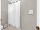Neutral bathroom featuring a white shower curtain and neutral tile floor at 361 Sarah Ln, Lawrenceville, GA 30046