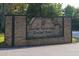 Stone entrance to Hanarry Estates North and Hanarry Pointe with lamp post lighting and manicured flower beds at 361 Sarah Ln, Lawrenceville, GA 30046