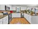 Bright kitchen featuring white cabinets, granite countertops, and stainless steel appliances at 361 Sarah Ln, Lawrenceville, GA 30046