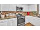 Efficient kitchen with white cabinets, granite countertops, and stainless steel appliances at 361 Sarah Ln, Lawrenceville, GA 30046