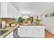 Granite counters and white cabinets, plus views of the dining room in this bright kitchen at 361 Sarah Ln, Lawrenceville, GA 30046