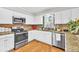 Well-lit kitchen with stainless appliances, granite countertops, and white cabinets at 361 Sarah Ln, Lawrenceville, GA 30046