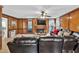 Comfortable living room featuring dark wood panels, fireplace, and a large leather sectional at 361 Sarah Ln, Lawrenceville, GA 30046