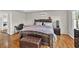 Comfortable primary bedroom with hardwood floors, a king bed, and a workspace at 361 Sarah Ln, Lawrenceville, GA 30046