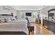 Well-lit primary bedroom featuring a king bed, hardwood floors, and neutral walls at 361 Sarah Ln, Lawrenceville, GA 30046