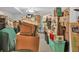 Gray-walled basement storage area crammed with an eclectic mix of packed containers and random household possessions at 361 Sarah Ln, Lawrenceville, GA 30046