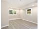 Finished basement with natural light, new flooring, and neutral paint at 530 Village Green Sw Ct, Lilburn, GA 30047