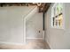 Basement area with exposed piping and a small window at 530 Village Green Sw Ct, Lilburn, GA 30047