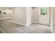 Neutrally painted room with a white door, a small window, and new laminate flooring at 530 Village Green Sw Ct, Lilburn, GA 30047