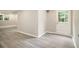 Finished basement with gray wood-look flooring and a white door leading to the exterior of the house at 530 Village Green Sw Ct, Lilburn, GA 30047