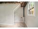 Unfinished basement space, featuring a closet, open ceiling and a window for natural light at 530 Village Green Sw Ct, Lilburn, GA 30047
