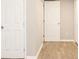 Basement area with neutral walls, two entry doors and new flooring at 530 Village Green Sw Ct, Lilburn, GA 30047