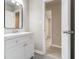 Clean bathroom featuring a white vanity and a well-lit mirror at 530 Village Green Sw Ct, Lilburn, GA 30047