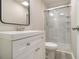 Updated bathroom featuring a modern vanity, toilet, and a glass-enclosed shower with marble-patterned walls at 530 Village Green Sw Ct, Lilburn, GA 30047