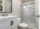 Updated bathroom with a new vanity, toilet, and a glass-enclosed shower with modern tile at 530 Village Green Sw Ct, Lilburn, GA 30047