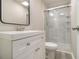 Bathroom with new vanity, toilet, and tiled stand-up shower with glass doors at 530 Village Green Sw Ct, Lilburn, GA 30047