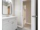 Bathroom featuring modern vanity and mirror at 530 Village Green Sw Ct, Lilburn, GA 30047
