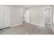 Neutral bedroom with wood-look floors, large closet, and adjacent bathroom with glass-enclosed shower at 530 Village Green Sw Ct, Lilburn, GA 30047