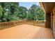 Exterior shot of a bright and sunny deck with a wooden railing overlooking the backyard at 530 Village Green Sw Ct, Lilburn, GA 30047