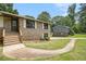 Close-up view of the brick facade and tidy landscaping of this well-maintained home at 530 Village Green Sw Ct, Lilburn, GA 30047