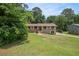 Traditional home with a spacious front yard surrounded by mature trees at 530 Village Green Sw Ct, Lilburn, GA 30047