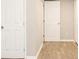 Neutral hallway featuring new laminate flooring and modern paint at 530 Village Green Sw Ct, Lilburn, GA 30047