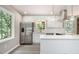 Modern kitchen with stainless steel appliances, white cabinetry, and ample counter space at 530 Village Green Sw Ct, Lilburn, GA 30047